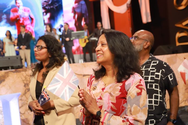 International delegate waving a flag at the gathering