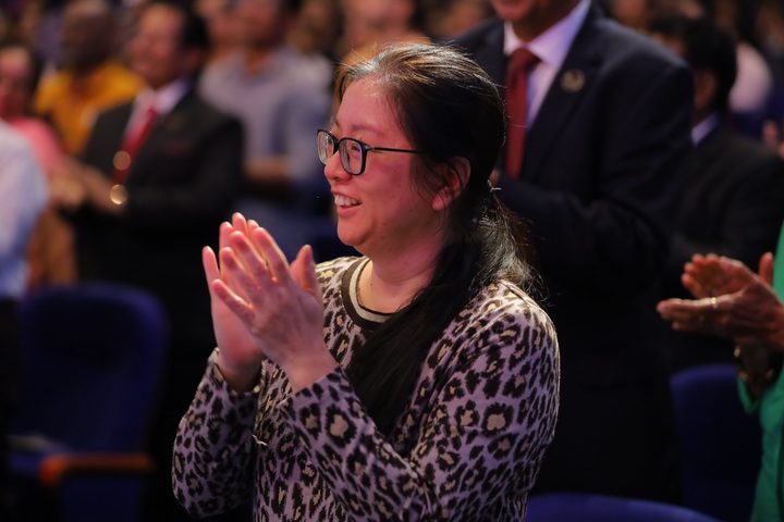 Guests worshipping with flags raised