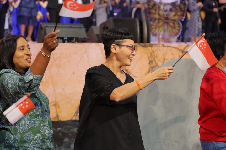 Attendee waving a Singapore flag